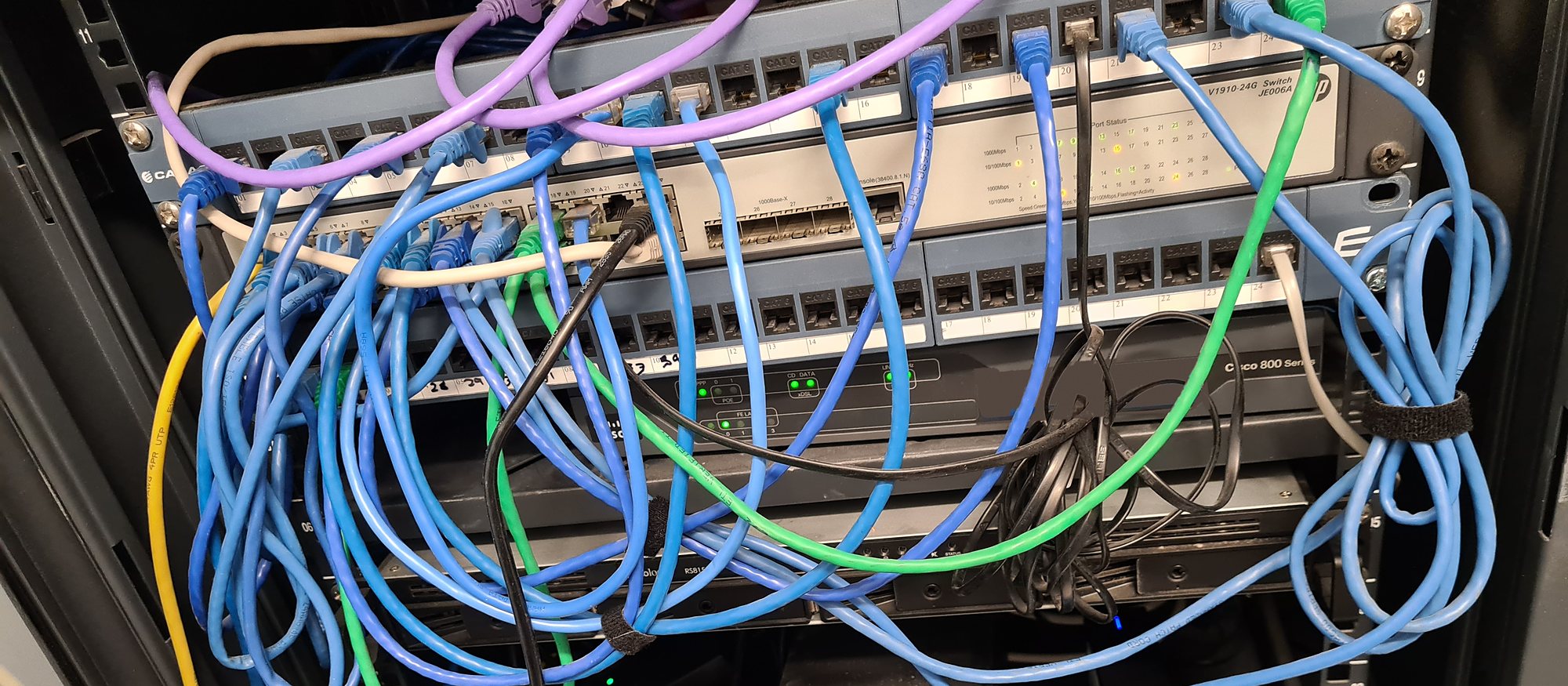 Tangled network patch leads in a business comms cabinet